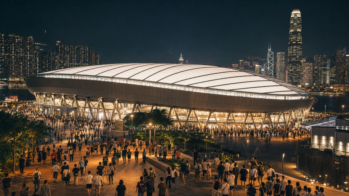 啟德體育園主場館夜晚亮燈,球迷沿通道進場,維港一帶高樓燈光在後方